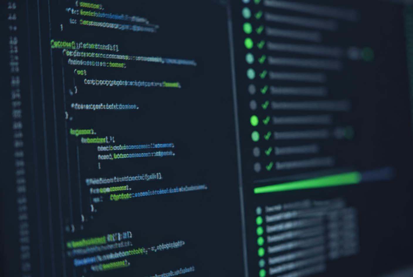 Programming editor beside a list of passing automated test results on a dark screen